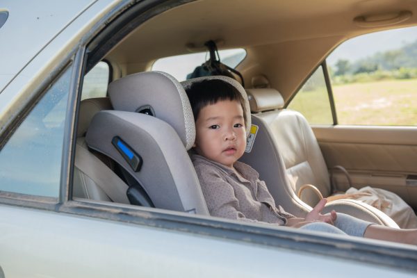 Little boy in a child safety seat sitting patiently in the back of a car.
happy asian family on mini van are smiling and driving for travel on vacation. happy family with spending time outdoor.